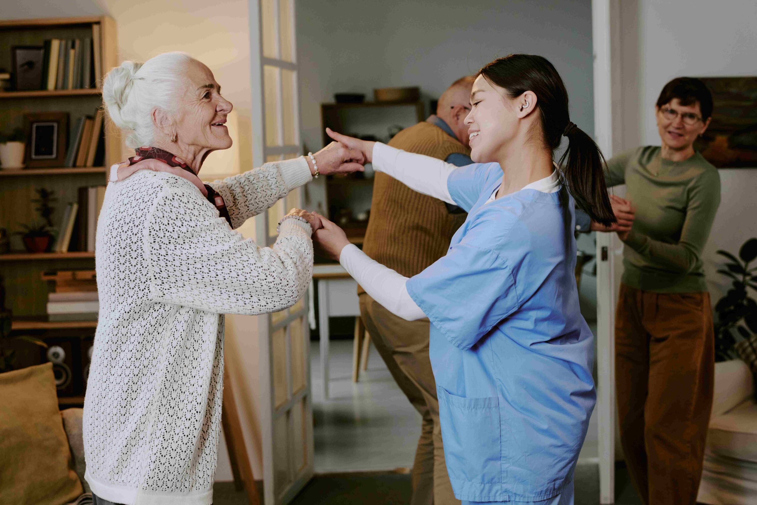 caregiver-dances-with-senior-woman-in-home-setting-2026-01-11-10-59-23-utc_11zon