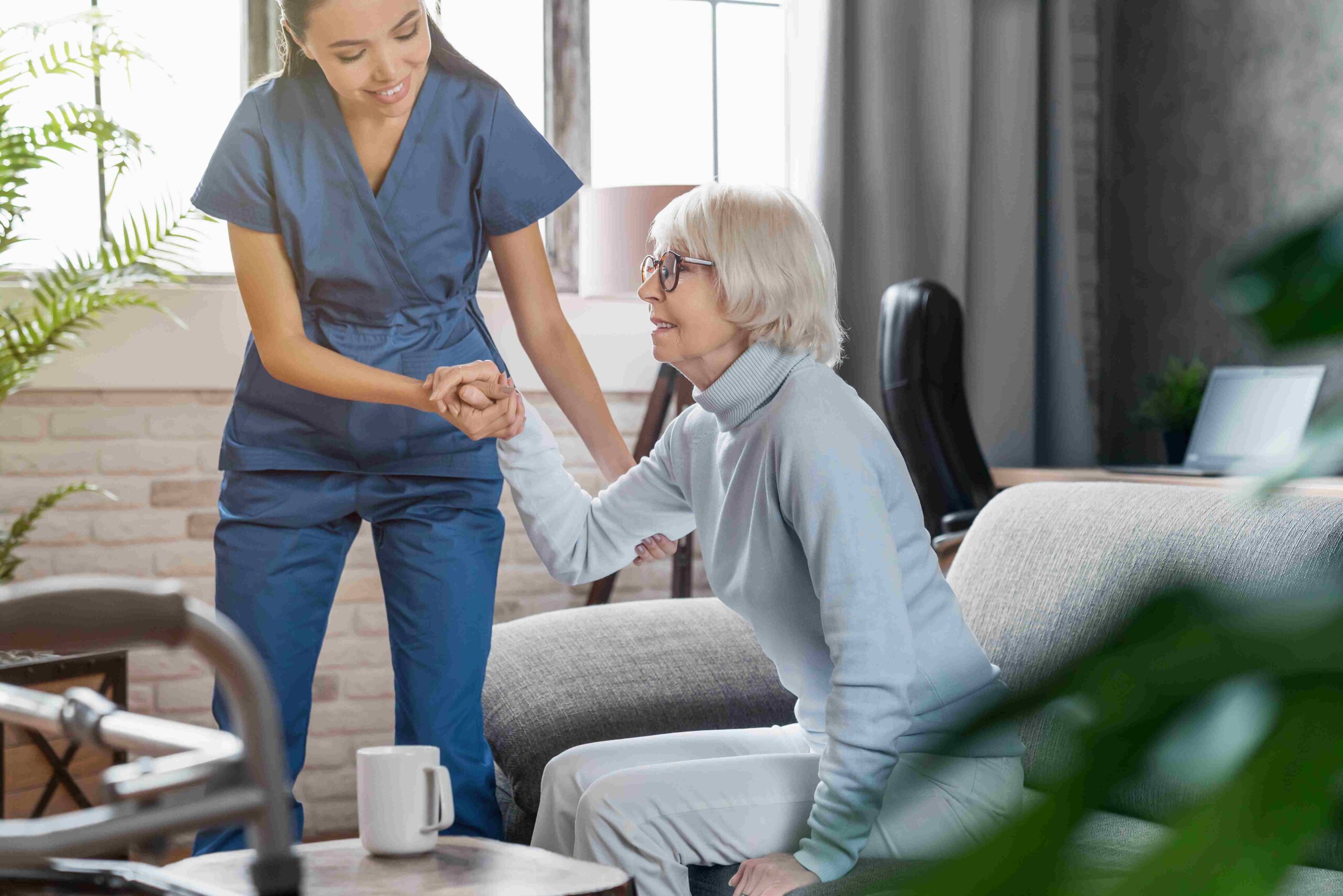 caring-nurse-helping-senior-woman-sitting-indoors-2026-03-17-07-19-58-utc_11zon