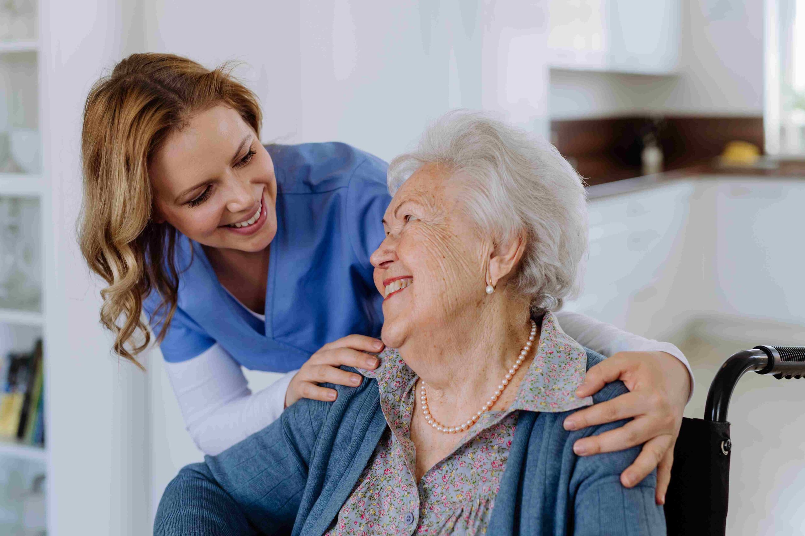 smiling-caregiver-with-senior-woman-in-wheelchair-2026-01-05-23-01-16-utc_11zon